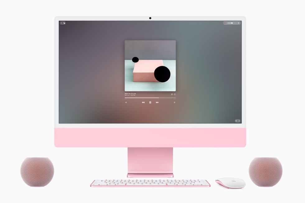 Два рожеві HomePod mini 2 поруч з рожевим iMac як колонки для комп'ютера